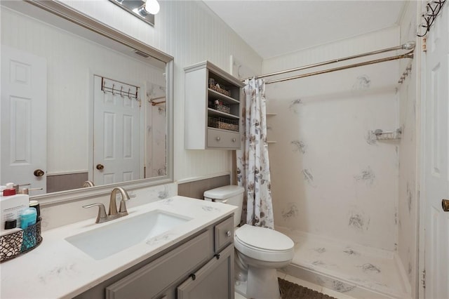 bathroom with walk in shower, vanity, and toilet