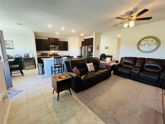 living room with light tile patterned floors and ceiling fan