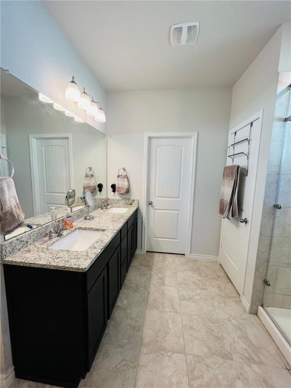 bathroom with vanity and walk in shower