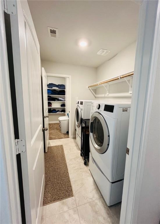 washroom featuring washer and clothes dryer