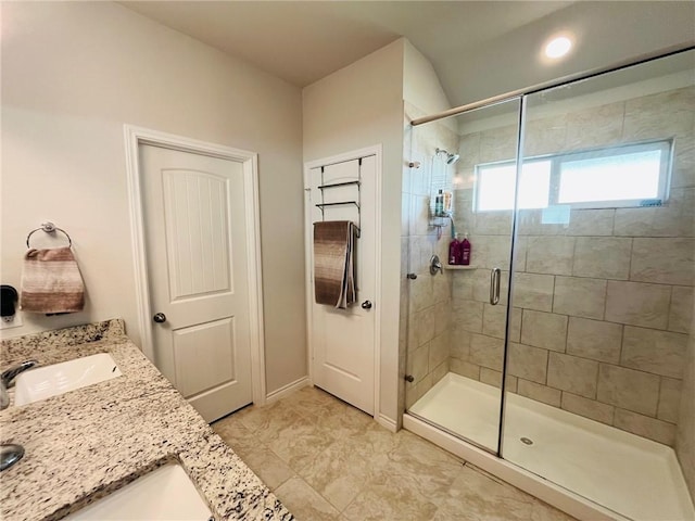 bathroom with a shower with door and vanity