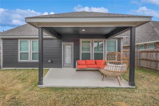 back of property featuring a patio area, a yard, and an outdoor hangout area