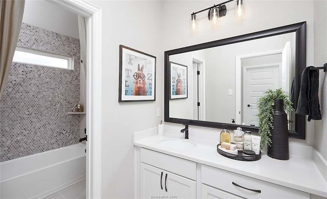 bathroom featuring vanity and tiled shower / bath