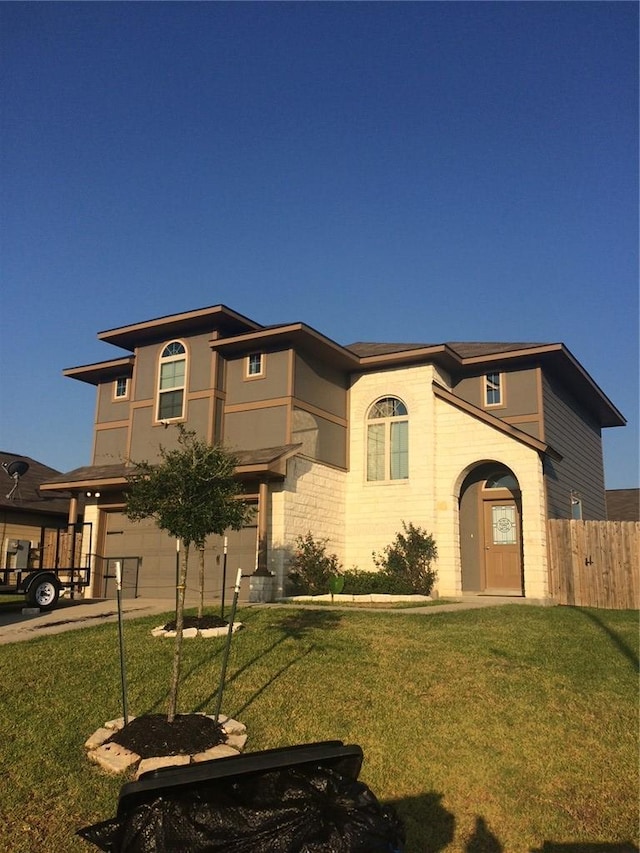 view of front of property featuring a front yard and a garage