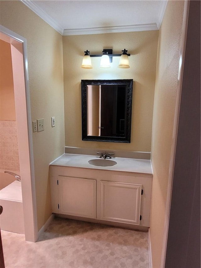 bathroom featuring a tub, vanity, and ornamental molding