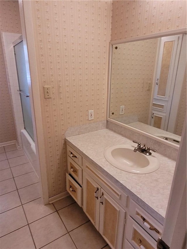 bathroom featuring tile patterned flooring, vanity, and shower / bathtub combination