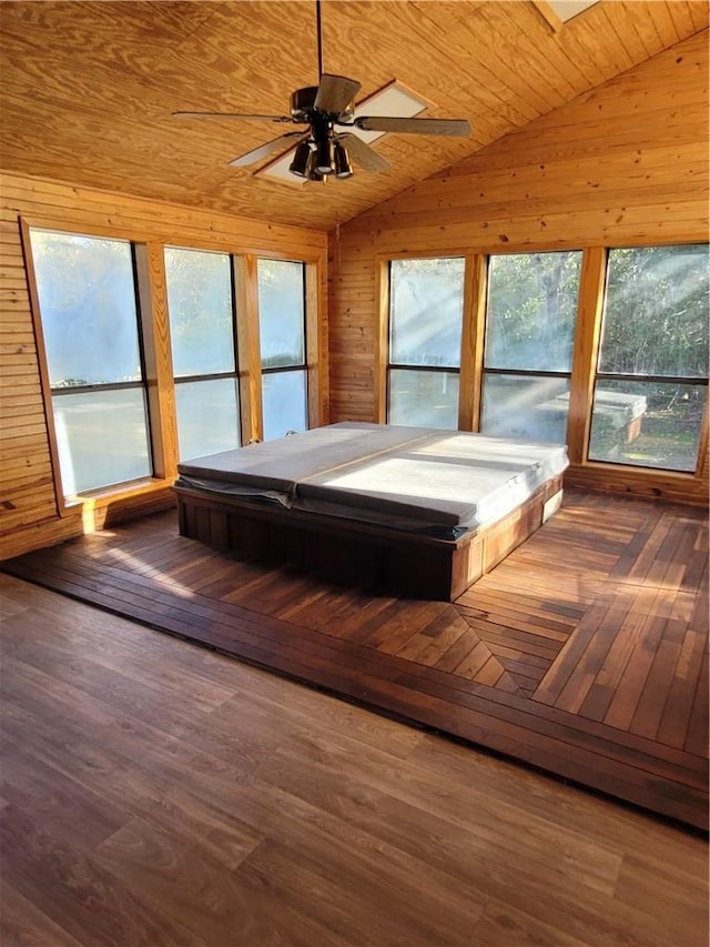 unfurnished bedroom featuring wood walls, vaulted ceiling, ceiling fan, dark hardwood / wood-style floors, and wood ceiling