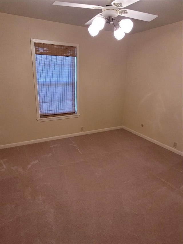 empty room with ceiling fan and carpet floors