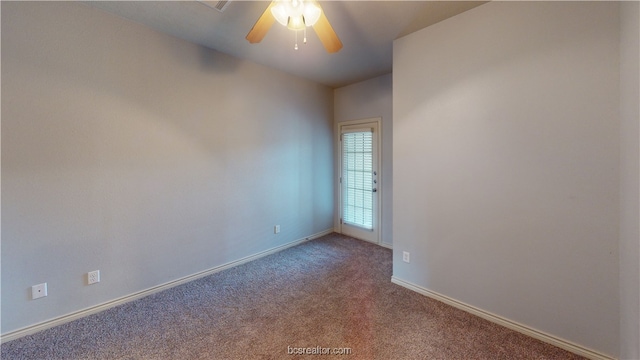 spare room featuring carpet flooring and ceiling fan