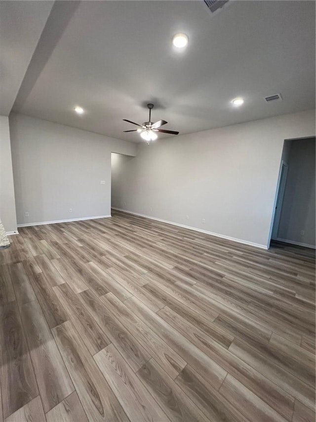 spare room with light hardwood / wood-style floors and ceiling fan