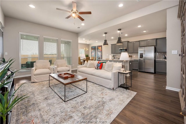 living room with ceiling fan and dark wood-type flooring