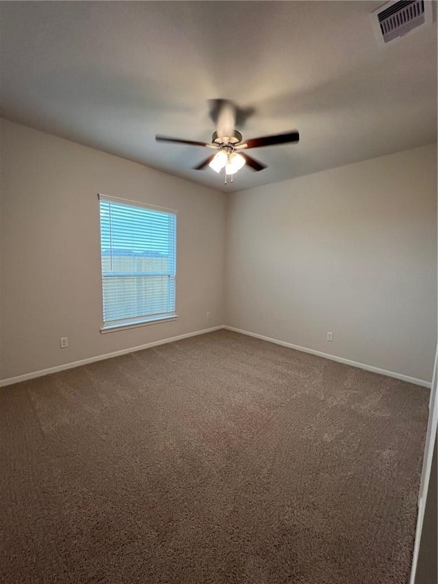 carpeted spare room with ceiling fan