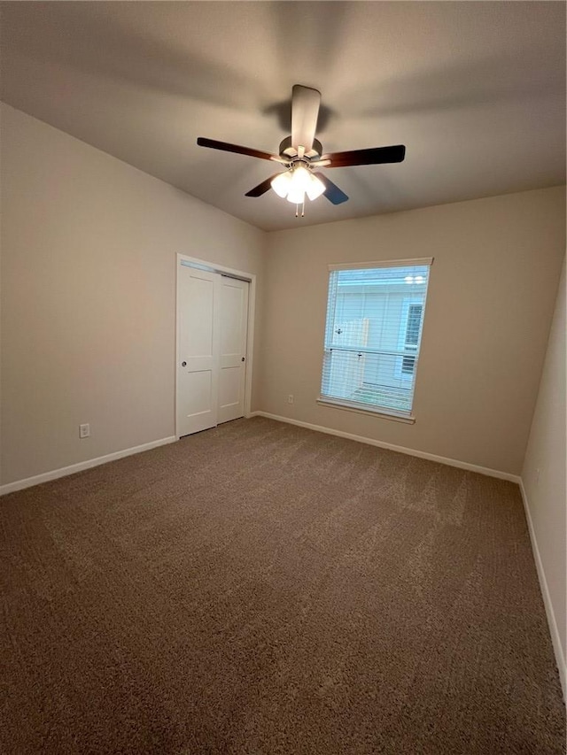 unfurnished bedroom featuring carpet flooring, a closet, and ceiling fan