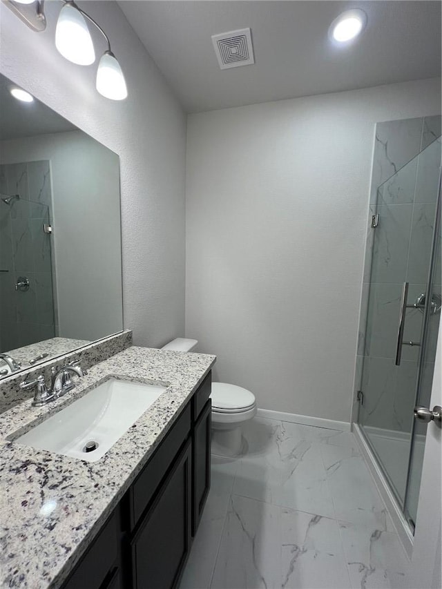 bathroom with vanity, toilet, and an enclosed shower