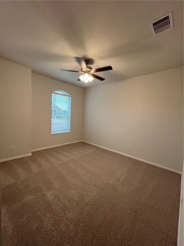 spare room with ceiling fan and carpet floors