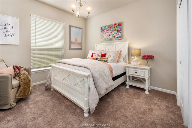 carpeted bedroom with a closet and an inviting chandelier