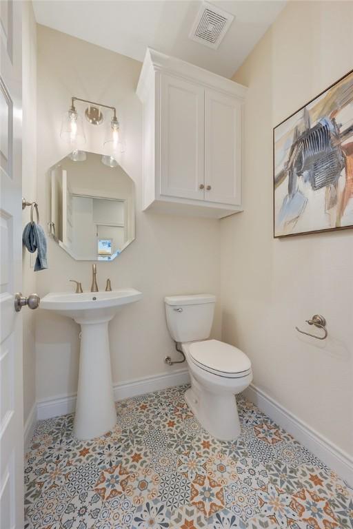 bathroom featuring toilet and tile patterned flooring