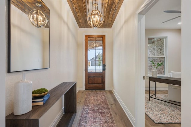 entrance foyer featuring hardwood / wood-style flooring, a chandelier, and wooden ceiling