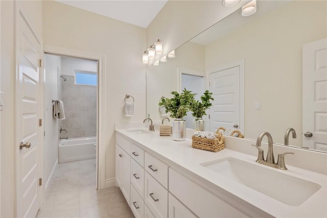 bathroom with tiled shower / bath combo, tile patterned flooring, and vanity