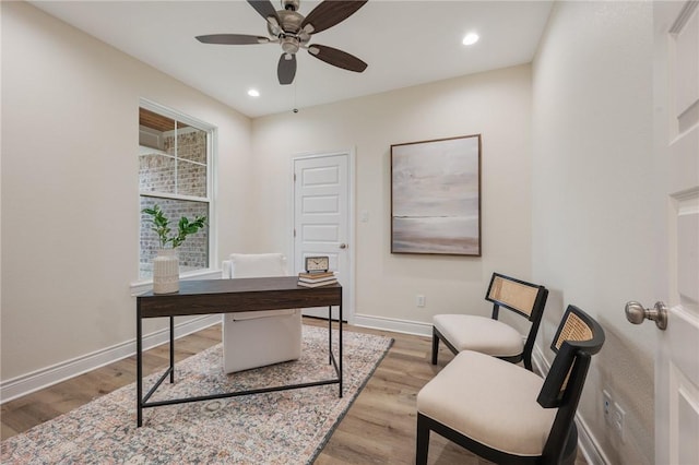 office with ceiling fan and light wood-type flooring