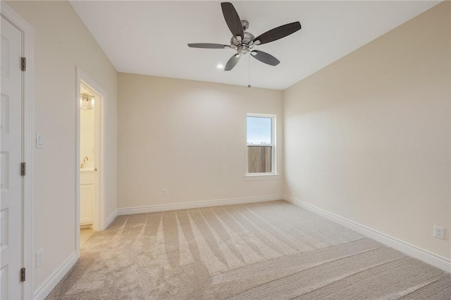 carpeted empty room featuring ceiling fan