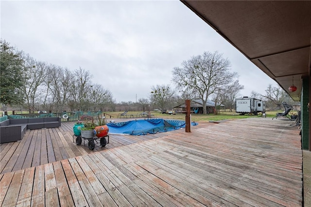 deck with outdoor lounge area and a covered pool