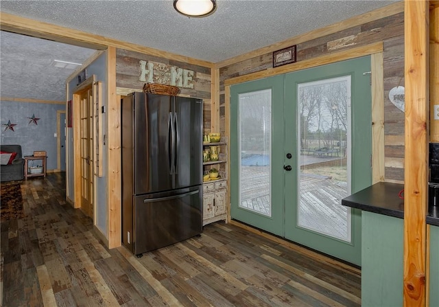 kitchen featuring french doors, dark hardwood / wood-style floors, refrigerator, and a textured ceiling