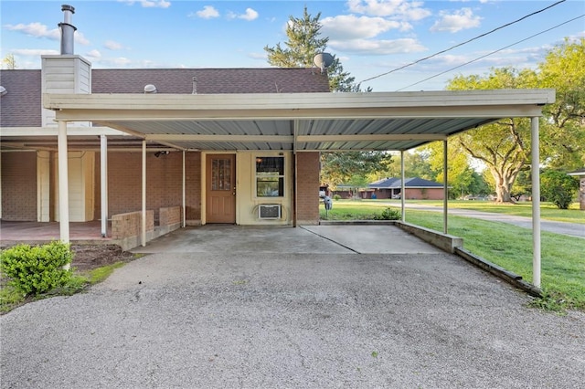 view of parking featuring an attached carport and aphalt driveway
