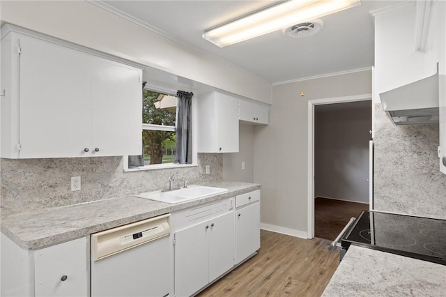 kitchen featuring light wood-style flooring, wall chimney range hood, dishwasher, a sink, and backsplash