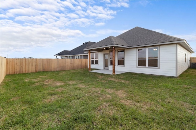 rear view of house with a patio area, a lawn, and ceiling fan