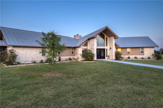 view of front of house featuring a front lawn and french doors