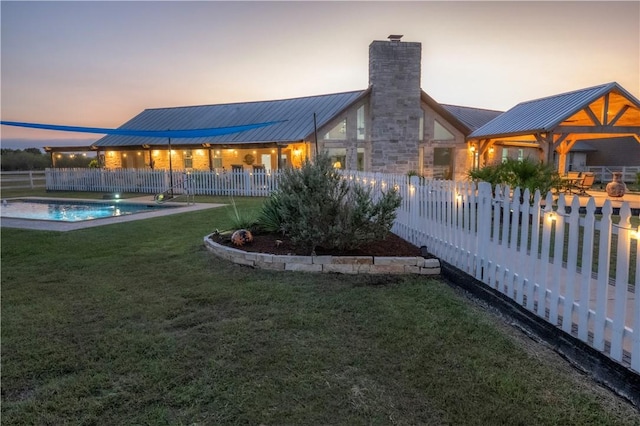 exterior space featuring a fenced in pool and a yard