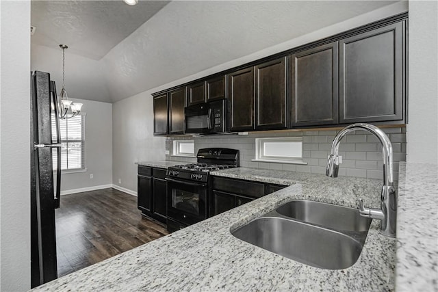 kitchen featuring black appliances, tasteful backsplash, dark wood-type flooring, and a sink