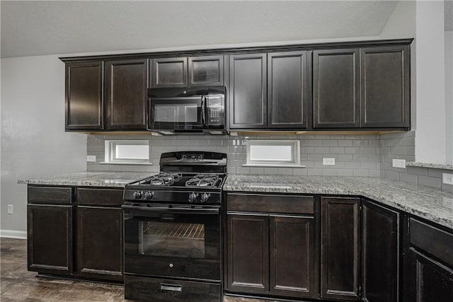 kitchen featuring dark wood-type flooring, black appliances, backsplash, baseboards, and light stone countertops