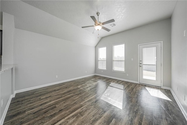 unfurnished living room with dark wood finished floors, lofted ceiling, baseboards, and ceiling fan