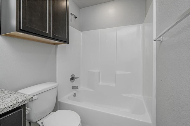 bathroom featuring toilet, bathtub / shower combination, and vanity