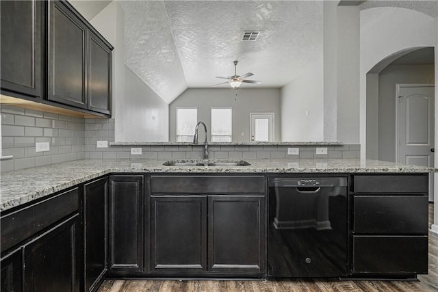 kitchen with visible vents, dishwasher, light stone counters, wood finished floors, and a sink