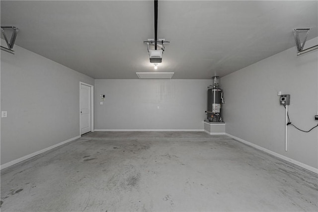 garage with gas water heater, a garage door opener, and baseboards