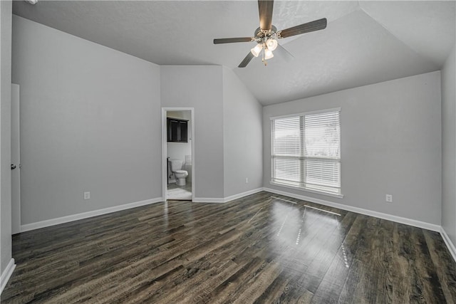 interior space with baseboards, lofted ceiling, dark wood-type flooring, and a ceiling fan