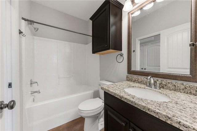 bathroom with vanity, toilet, and washtub / shower combination