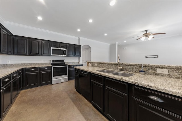 kitchen featuring a sink, ceiling fan, appliances with stainless steel finishes, arched walkways, and dark cabinets
