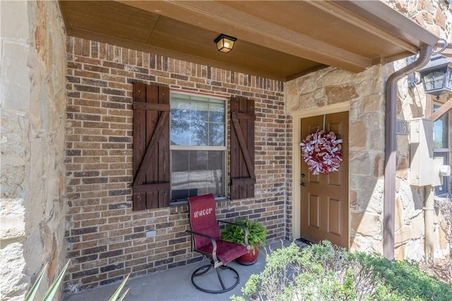 entrance to property with brick siding and stone siding