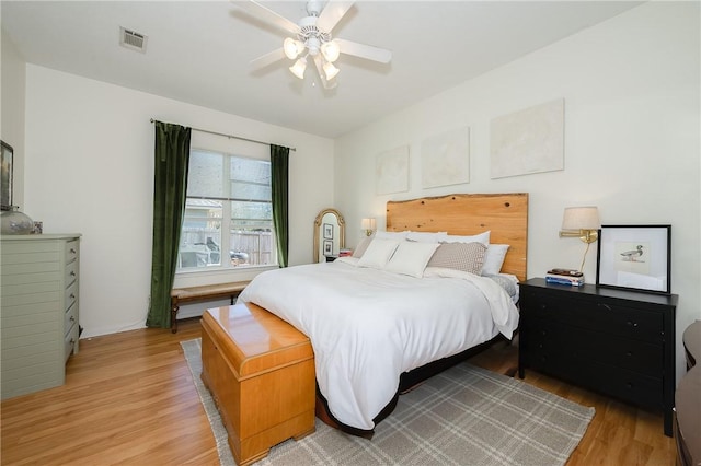 bedroom with ceiling fan and light hardwood / wood-style flooring