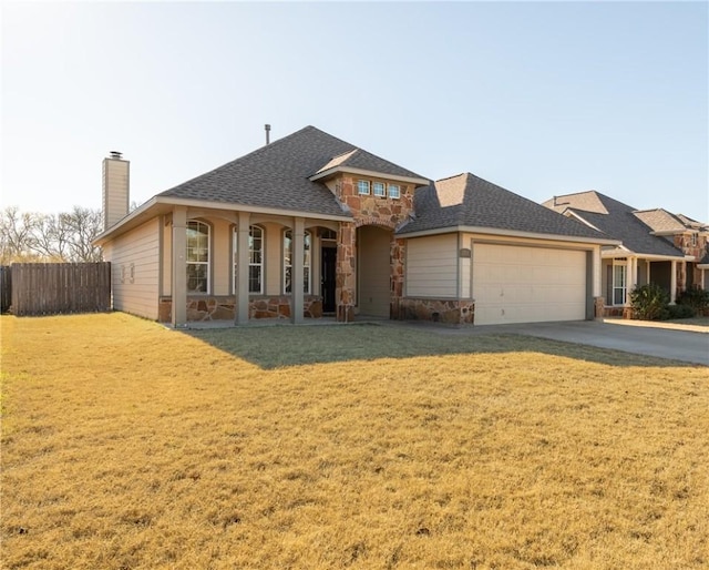 view of front of house with a garage, a porch, and a front lawn