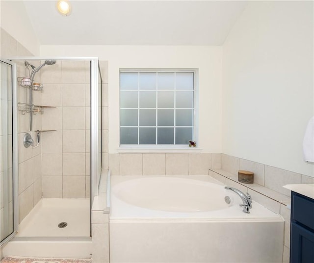 bathroom with vanity and independent shower and bath