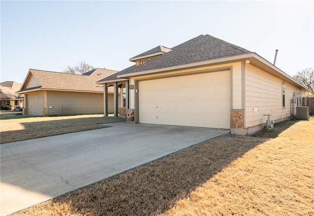 view of front of property featuring cooling unit and a garage