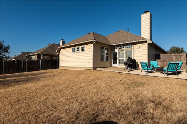 rear view of property featuring a patio and a lawn