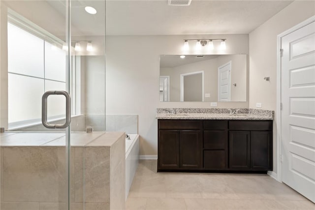 bathroom featuring separate shower and tub and vanity