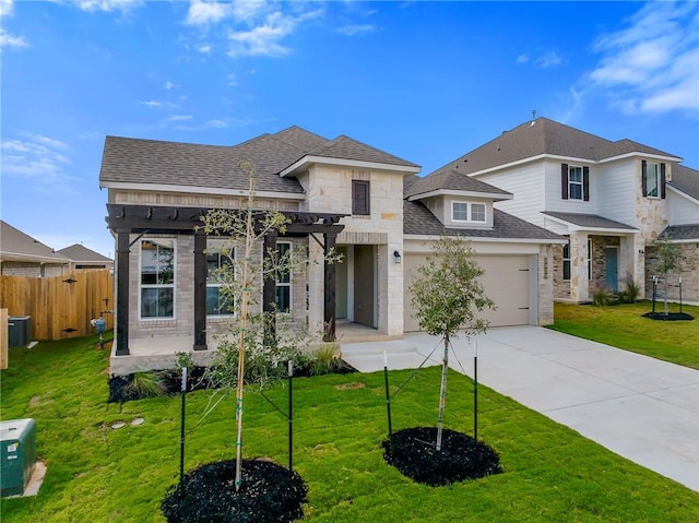 view of front of home featuring a front yard and a garage