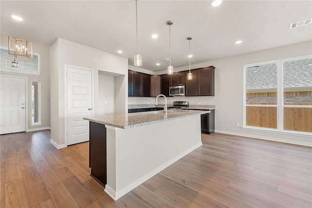 kitchen featuring plenty of natural light, light wood-type flooring, and stainless steel appliances